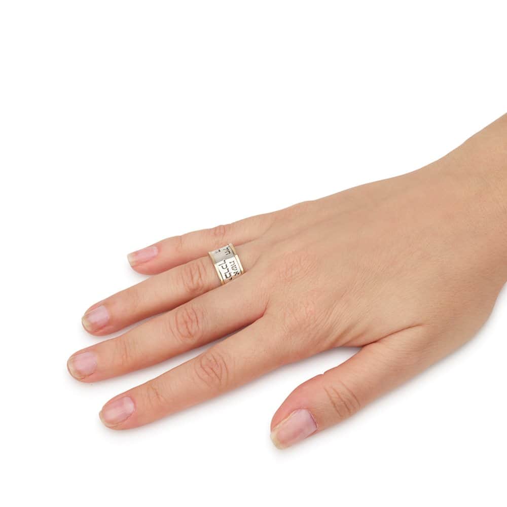 Woman wearing a wide silver and gold Hebrew blessing ring featuring Eshet Chayil and the Priestly Blessing