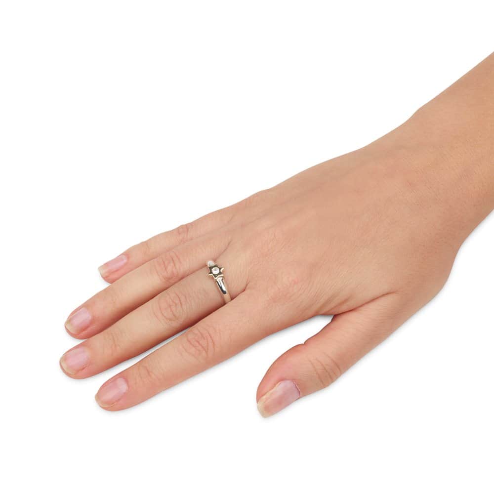 Woman wearing a delicate sterling silver ring with gold Star of David and sparkling CZ center on her finger